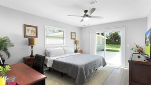 A bedroom with a bed, desk, chair, and a ceiling fan. - The Horseman's Retreat (Ocala)