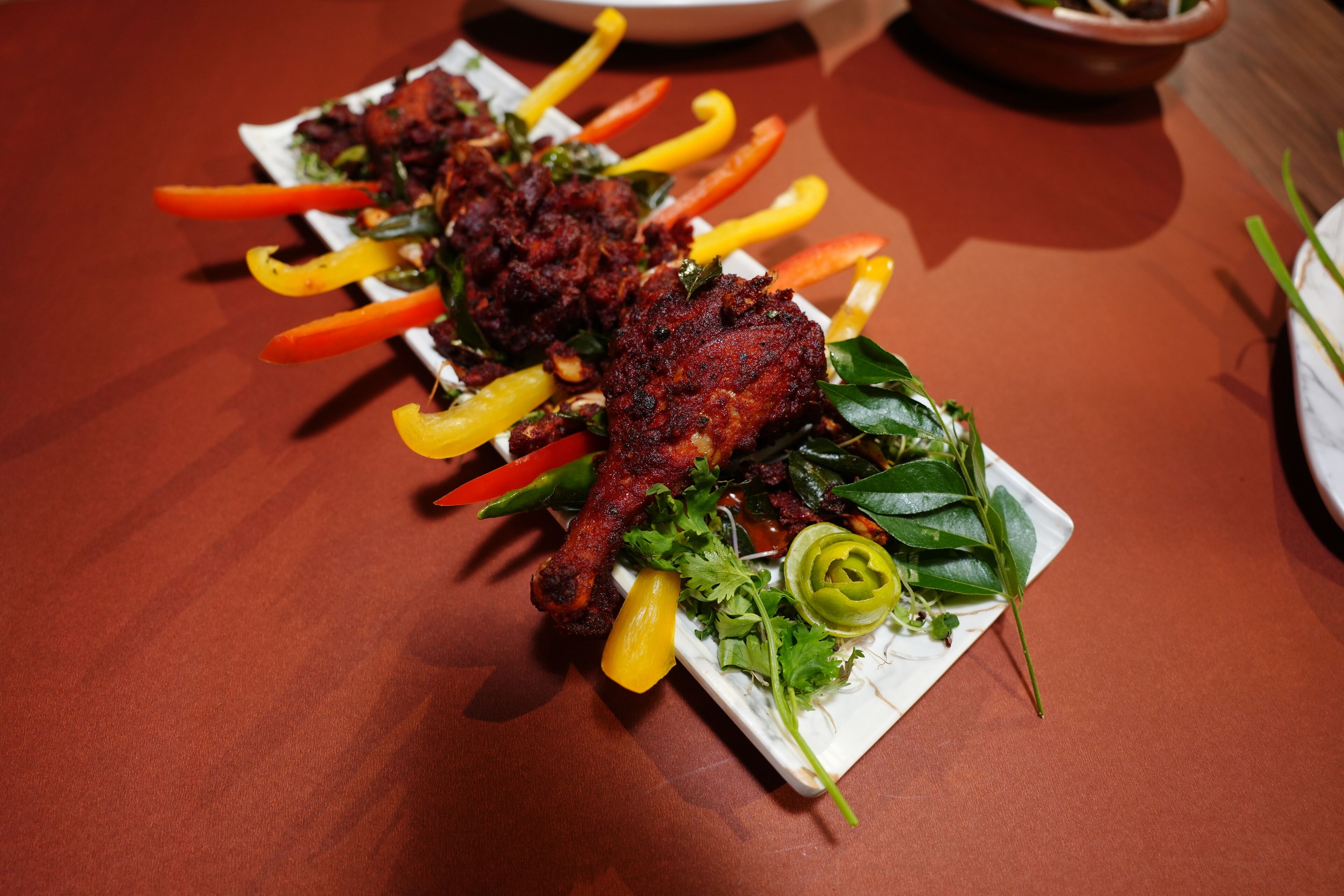 A plate of grilled chicken with vegetables.