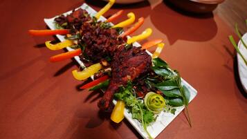 A plate of grilled chicken with vegetables.