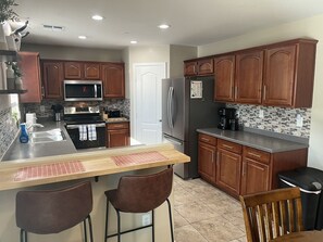 Fridge, microwave, oven, stovetop - AZ Sun & Serenity: 4BR home w/Heated Pool, BBQ Island, Prime location– Sleeps 12 (Surprise)