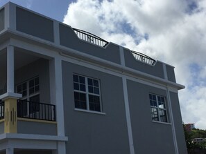 A multi-story building with balconies and large windows.