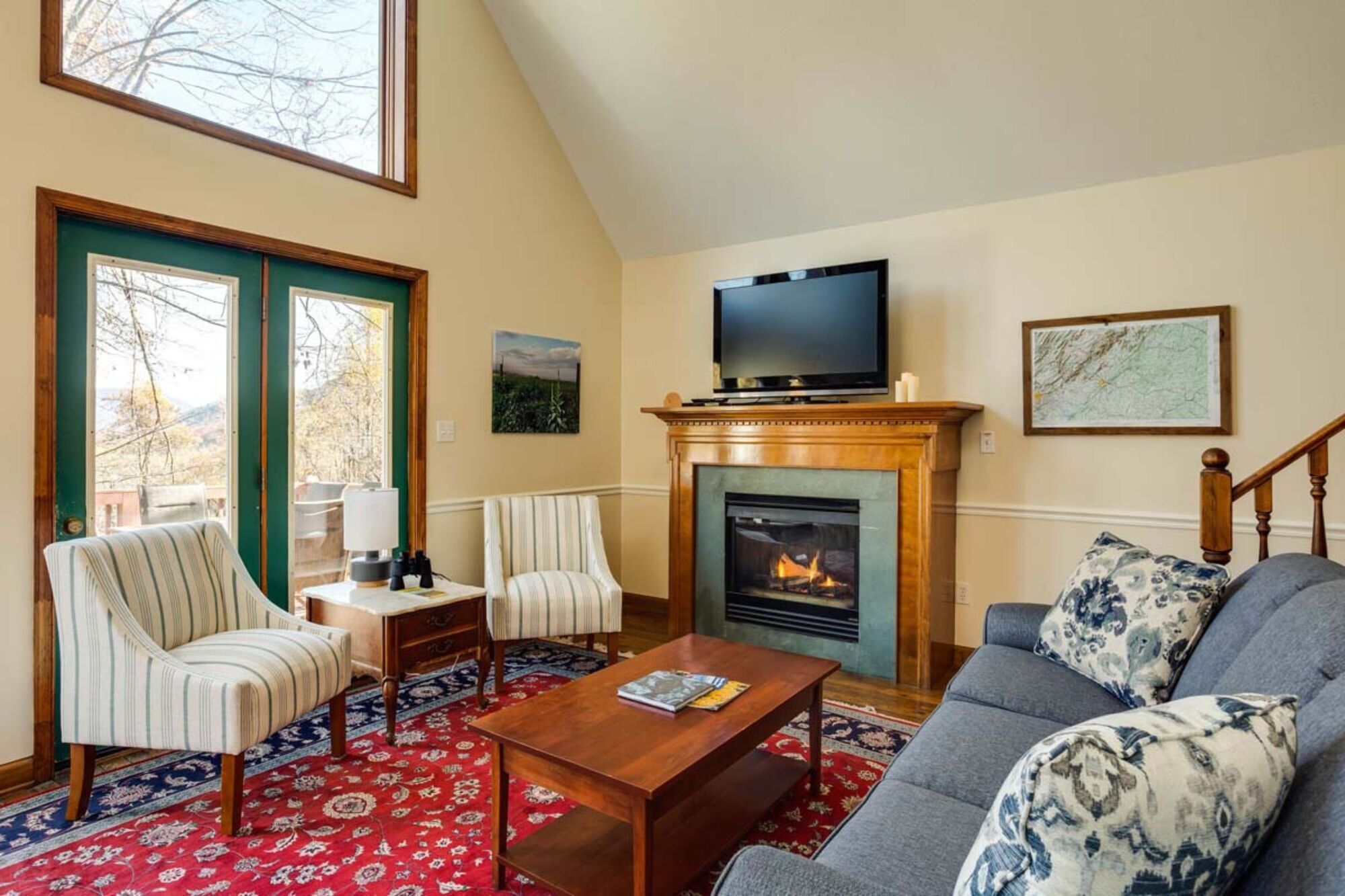 A living room with a fireplace, a television, and a sofa.