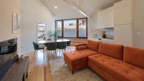 Un appartement moderne comprenant un coin repas, un canapé et une cuisine.