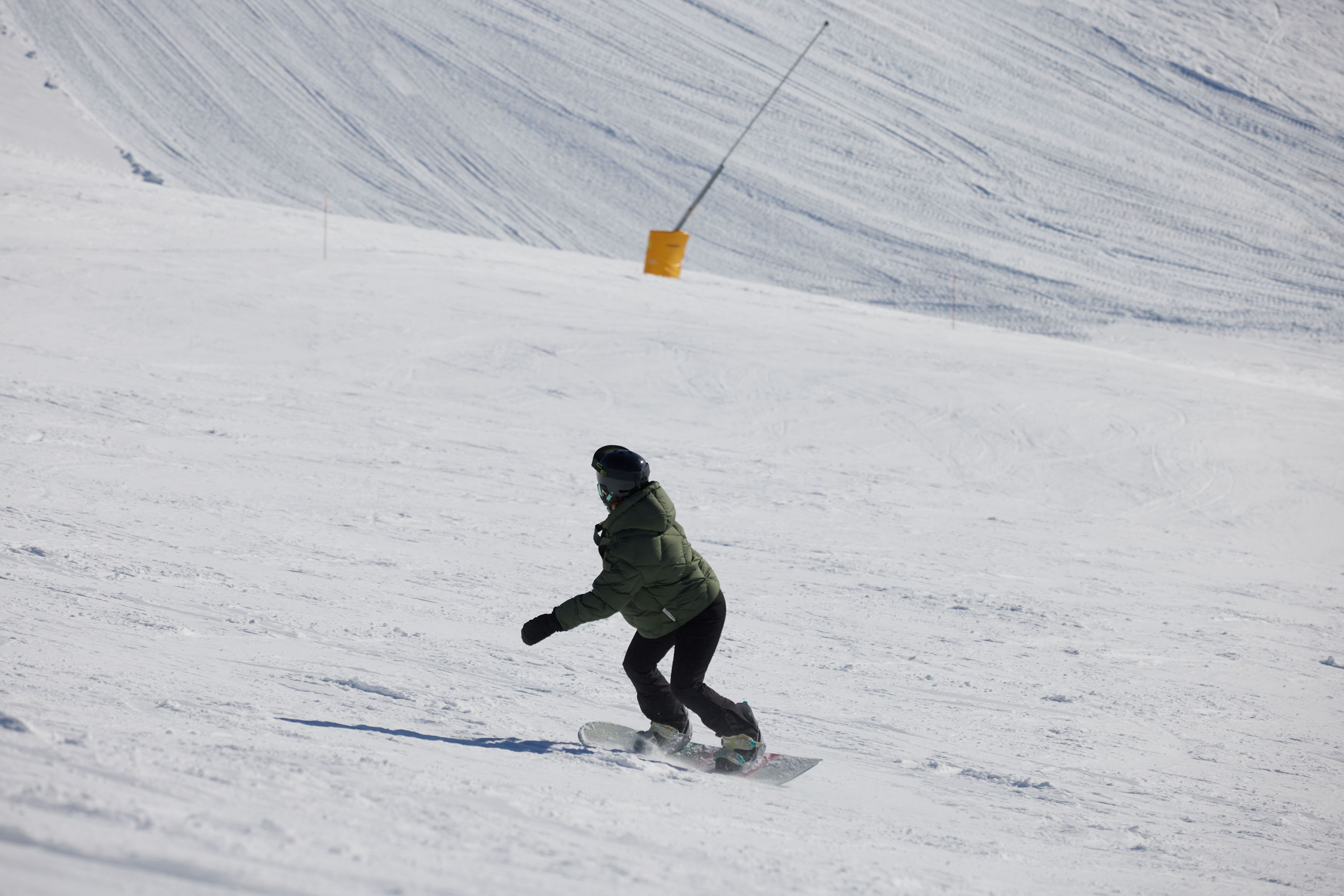 A snowboarder on a snowy slope.