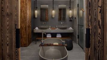 A modern bathroom with a large freestanding bathtub, two sinks with mirrors, and wooden accents on the walls.