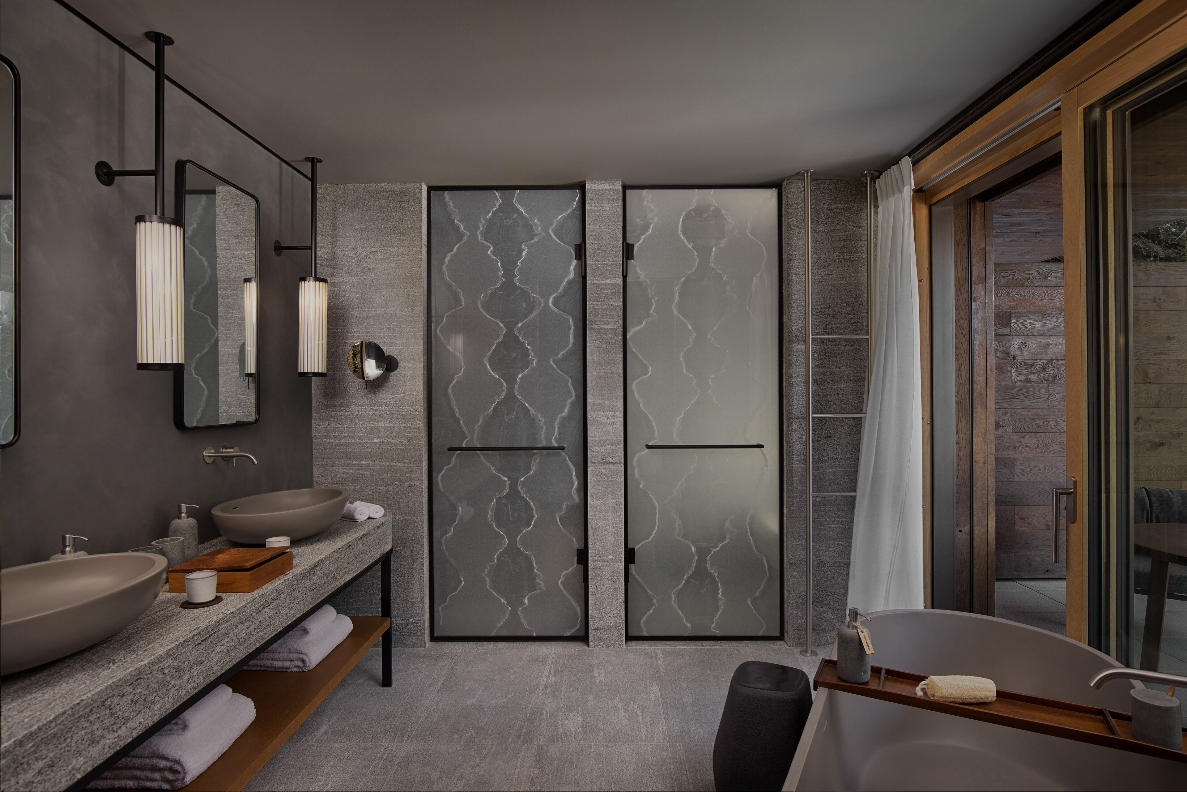 A modern bathroom with a large sink, a bathtub, and a shower area.