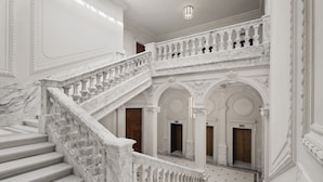 A grand marble staircase with multiple landings and ornate railings. - Six Senses Rome (Rome)