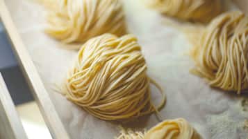 A close-up of pasta dough balls on a baking tray.