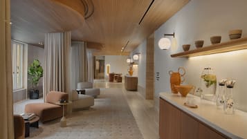 A modern interior with a wooden ceiling, a long hallway, and a counter with decorative items.