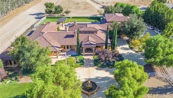 A large estate with multiple buildings, a central courtyard, and a well-maintained garden.