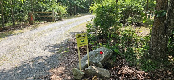 A signpost with '102 Wells' and 'The Woodlands' indicating a campground.