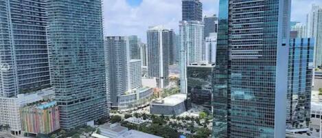 A high-rise urban area with modern skyscrapers, a mix of residential and commercial buildings, and a clear sky.