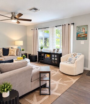 Bright living room with plenty of natural light and games galore