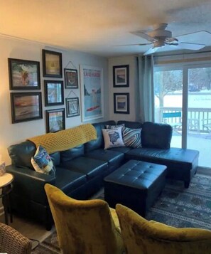 Relax in this inviting living room with a sofa, coffee table, and stunning views of the surrounding landscape.