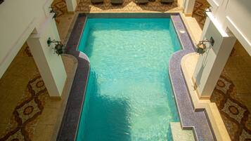 Outdoor pool, open 7:00 AM to 8:00 PM, pool umbrellas