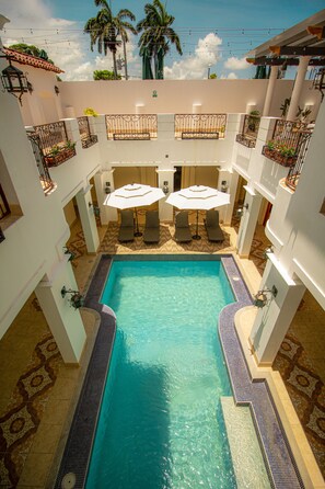 Outdoor pool, open 7:00 AM to 8:00 PM, pool umbrellas