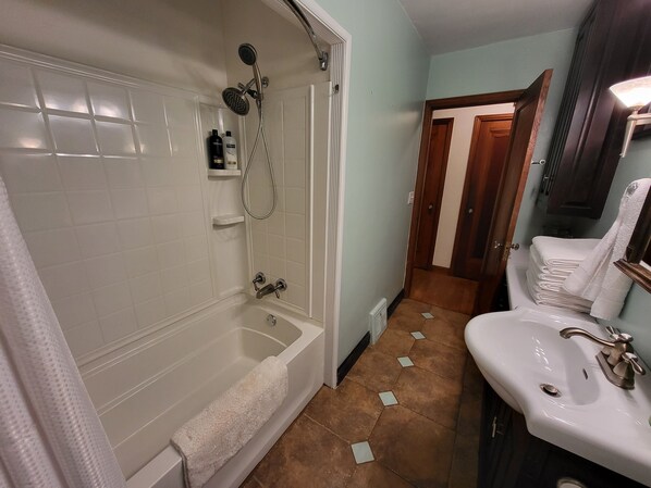 Ein Badezimmer mit Badewanne, Dusche und Waschbecken.