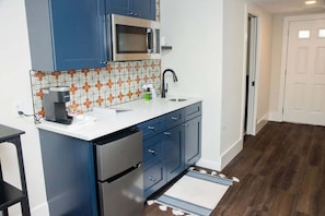 Fridge, microwave, coffee/tea maker, cookware/dishes/utensils