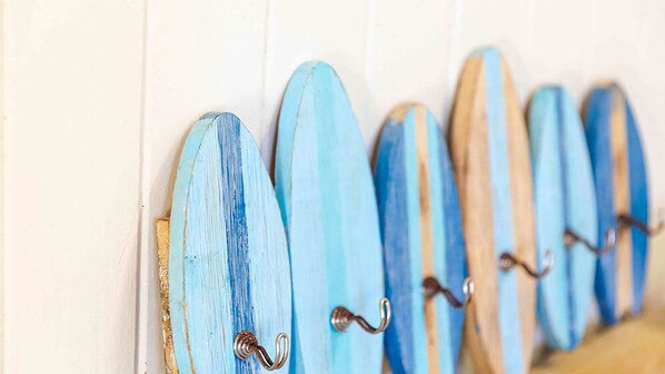 A row of surfboards mounted on a wall.