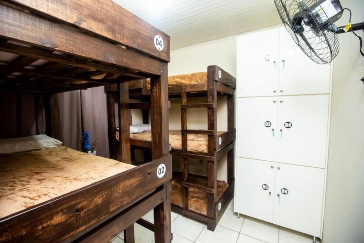 Bunk beds with numbers, a fan, and a white cabinet with locks.