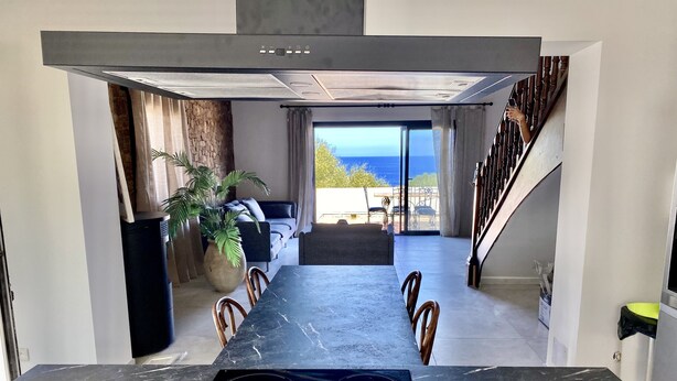 A modern kitchen with a built-in stove, marble countertops, and a view of the outdoors. - Casa Prima (Monticello)