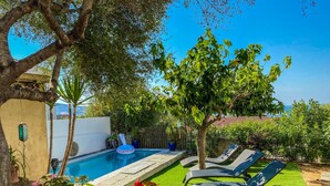 A swimming pool with a lounge area, surrounded by greenery and a view of the sea. - Casa Prima (Monticello)