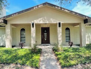 Stunning two-story building with a central entrance and beautifully manicured lawn.