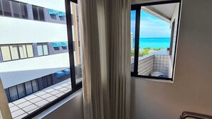 A room with a view of a balcony and the ocean. - Apartamento Catamarã Portiville (Maceió)