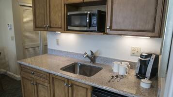 Fridge, microwave, coffee/tea maker, cookware/dishes/utensils