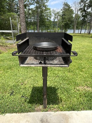 Enjoy outdoor cooking with a standalone barbecue grill on the lawn.