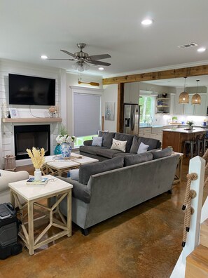 Relax in this stylish living room with a comfortable sofa, flat-screen TV, and fireplace.