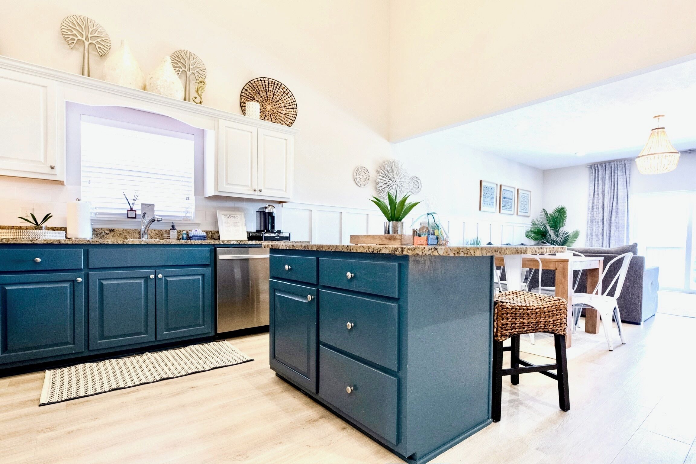 Una cocina moderna con armarios azul oscuro, una encimera de granito y una isla central.