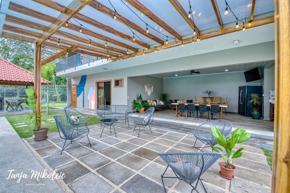 An open-plan living area with a patio, seating, and a dining area.