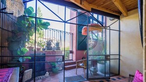 A room with a glass partition, a wooden ceiling, and a tiled floor. - Located in the trendy West end of Fremantle, this stylish Airbnb is perfect for beach lovers and urban explorers alike. (Fremantle)
