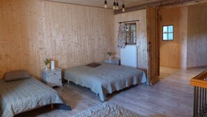 A wooden-paneled bedroom with a bed, two bedside tables, a dresser, and a window. - Gîte for 2 to 6 people: relaxation and easy living (Phalsbourg)