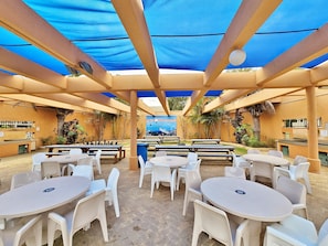 Enjoy meals in a casual, open-air setting surrounded by a scenic seascape mural.