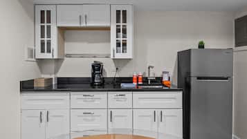 Fridge, coffee/tea maker, cookware/dishes/utensils, dining tables