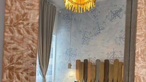 A modern bedroom with a bed, a wooden headboard, and a decorative ceiling light. - Pharus miseni (Bacoli)