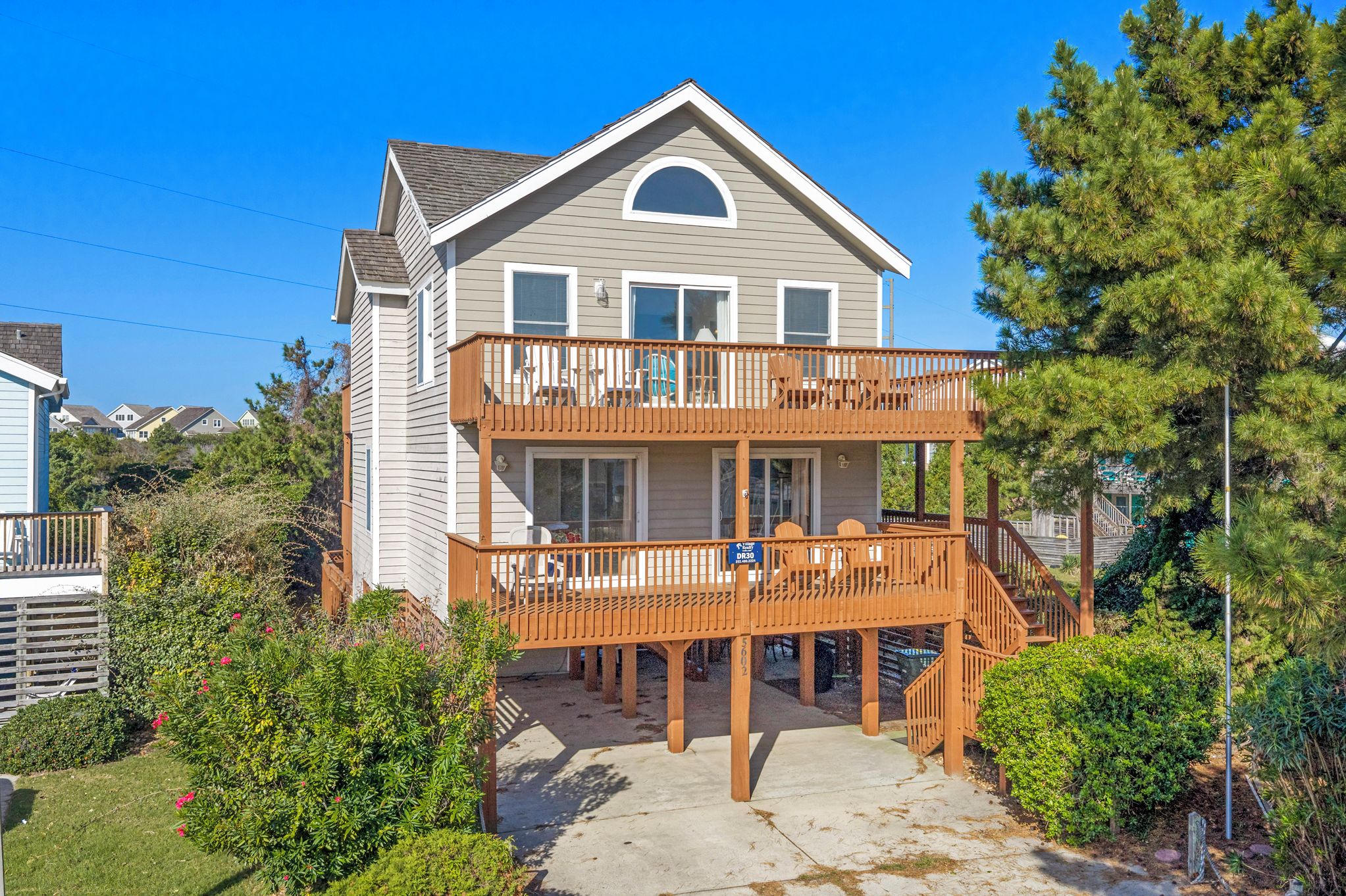 A two-story house with a balcony and a staircase leading to the upper level.