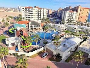 A resort with a swimming pool, a gym, and a bar.