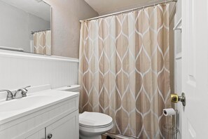 Combined shower/bathtub, towels, toilet paper