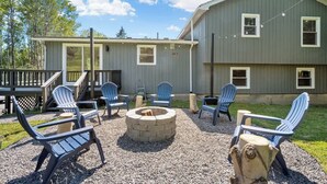 A house with a deck, outdoor seating, and a fire pit. - Finger Lakes ~ Firepit, Spacious, Wine Country (Skaneateles)