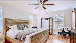 A bedroom with a wooden bed, a ceiling fan, and a nightstand. - Lakefront retreat for family, friends & fun! (Lake Norman of Catawba)