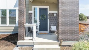 A house with a front porch, a door with a wreath, and a mailbox. - 4 BEDROOM MODERN HOME, FREE PARKING, A/C, W/D,WIFI (Westminster)