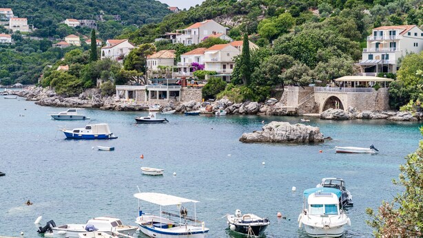 A coastal village with boats docked along the shore, stone buildings, and a stone bridge. - Hidden Gem Apartment - Two Bedroom Apartment with Terrace and Sea View (Molunat)