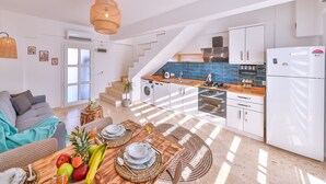 A modern kitchen with white cabinets, a built-in oven, and a refrigerator. - Villa Ay (Kas)