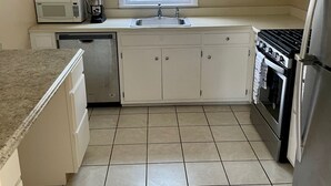 A kitchen with white cabinets, a microwave, a sink, a stove, and a dishwasher. - The Village - Private apartment w/ parking 5 min walking (Mamaroneck)