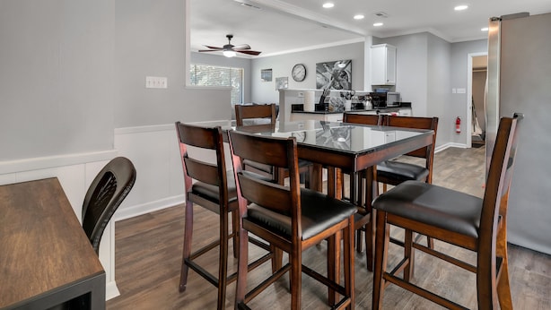A modern kitchen with a dining area.