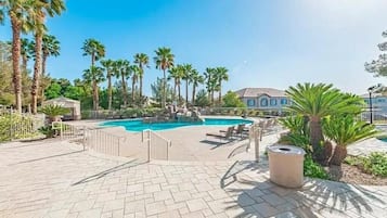Relax by the pool surrounded by palm trees and enjoy the serene atmosphere.