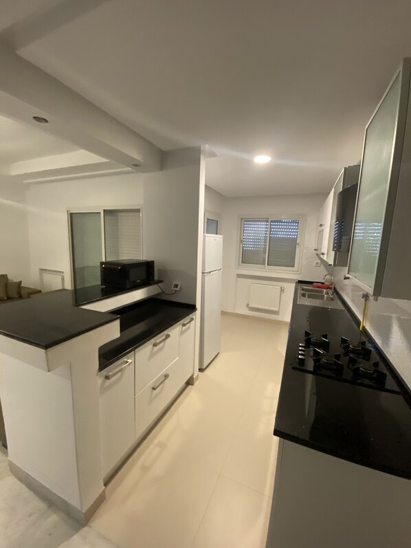 Fridge, microwave, stovetop, coffee/tea maker